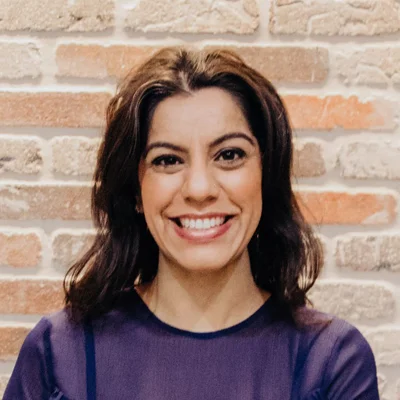 Dr. Rosy Gill smiling in a professional portrait.