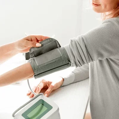 Patient having their blood pressure measured with an automatic cuff.